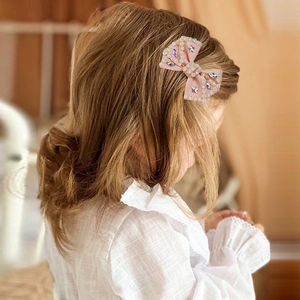 Sparkly light pink bow hair clip for girls with rhinestones and colorful star gems