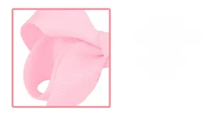 Detail shot of the pink grosgrain ribbon texture and handcrafted bow hair accessory