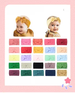 Detail view of 25 multicolor soft nylon baby bow headbands in a variety of vibrant shades
