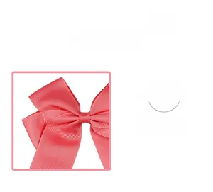 Detail view of the pink ribbed grosgrain bow hair clip showing textured fabric material