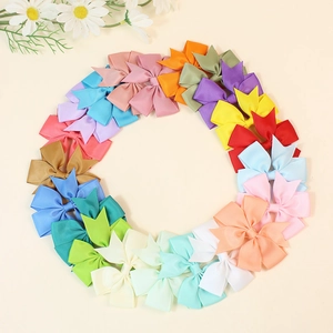 Colorful handmade grosgrain ribbon hair bows in 21 vibrant shades arranged in a circle