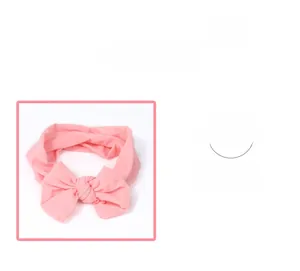 Detail of pink nylon baby headband showing soft fabric texture and decorative bow