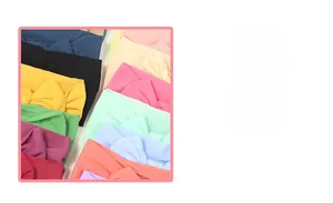 Close-up of soft nylon baby headbands with bows in various colors showing high elasticity