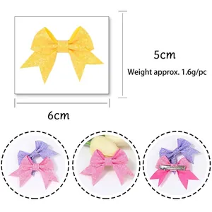 Glitter swallowtail bow hair clips in yellow pink and purple for kids measuring 6x5cm