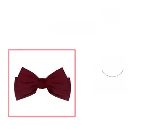 Detailed macro view of the double-layered matte satin fabric on the wine red bow hair clip