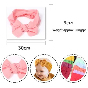 Soft nylon infant headband with a large bow available in diverse solid colors