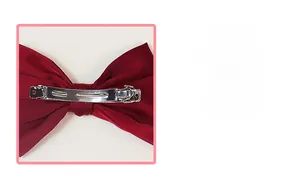 Close-up of wine red satin bow hair clip with durable silver metal spring mechanism back