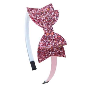 Pink sequin glitter double fishtail bow headband for kids on a white background