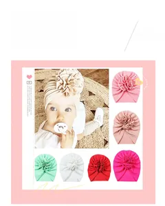 Detailed view of elastic baby turbans with large flower knots in various colors