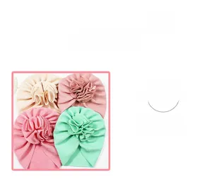 Detailed view of four baby waffle turban hats in pastel colors with large fabric flowers