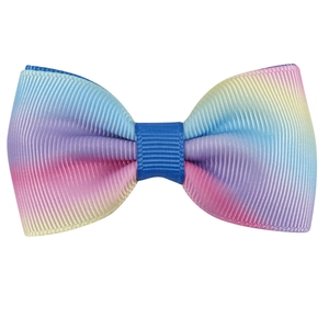 Detail of colorful rainbow gradient grosgrain ribbon bow with textured fabric weave