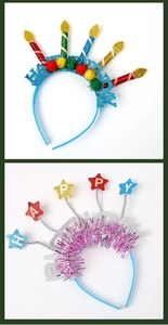 Detail view of colorful birthday party headbands with glitter candles and festive stars