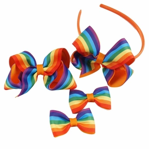 Rainbow ribbed ribbon bow set including one headband and four clips on white background