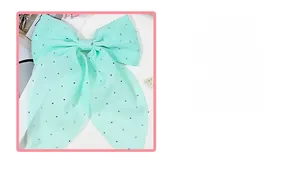 Détail d'une barrette à nœud vert menthe avec strass argentés brillants pour femmes
