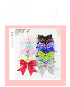Set of 14 colorful handmade satin bow hair clips in various vibrant solid colors