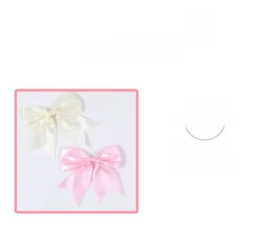 Detail view of handmade satin hair clips in cream white and pink colors with silky finish