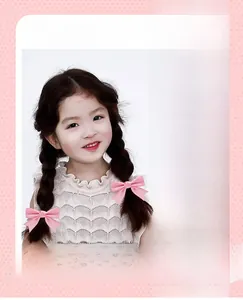 Detailed view of colorful macaron polyester hair bows worn on a child's braided hairstyle