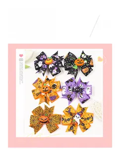 Detailed view of Halloween hair clips with pumpkin, ghost, and spider web ribbon patterns