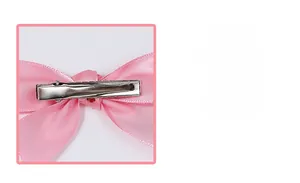 Detail view of the silver metal duckbill clip on the pink satin hair bow