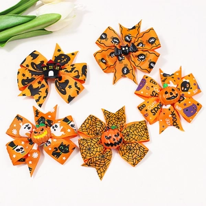 Five pieces of orange Halloween grosgrain ribbon bows with festive cartoon patterns