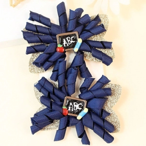 Handmade navy blue spiral ribbon hair clips with golden glitter and ABC school theme