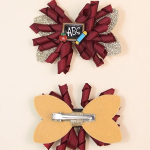 Handmade spiral glitter bow hair clips for girls with school-themed resin accents