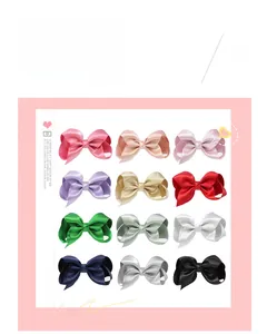 Detailed grid view of twelve colored satin bow hair clips for children in diverse shades