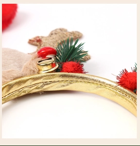 Close-up detail of Christmas headband with golden bells, red mushrooms, and reindeer antlers