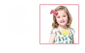 Detailed view of a pink satin multilayered bow hair clip worn by a young child