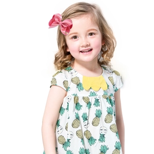 Pink satin ribbon bow hair clip for girls worn by a child model with floral dress