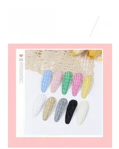 Detailed set of 10 fabric snap hair clips in assorted colors and plaid textures