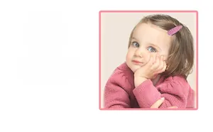 Close-up of pink textured fabric drop hair clip worn by a toddler on a soft background