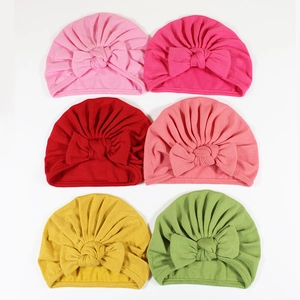 Soft cotton baby turban hats with large bows in six vibrant colors for infants
