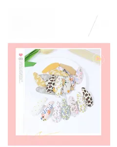Detailed set of fabric covered snap hair clips with floral, leopard, and polka dot patterns