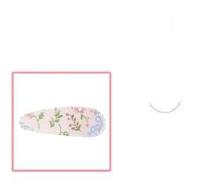 Detail of fabric-wrapped teardrop hair clip featuring pink floral patterns and wavy edges