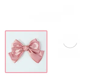 Detailed close-up of pink satin bow hair clip showing smooth fabric texture and finish