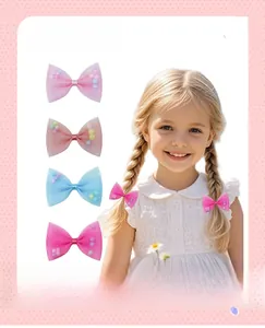 Detail of mesh hair bows for girls featuring colorful interior pom pom balls and soft tulle
