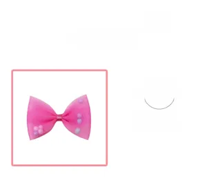 Close-up of pink mesh bow hair clip with colorful interior pom-poms for girls