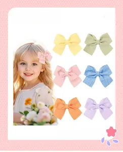 Détail de 6 barrettes nœuds en tissu doux aux tons macaron pour les enfants