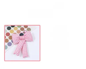 Detail of pink plaid bow hair scrunchie with long ribbons made of soft cotton fabric