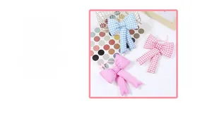 Detailed view of padded fabric bow charms in pink and blue plaid and solid colors