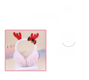 Detail of plush pink Christmas reindeer earmuffs with red antlers and festive bow bell