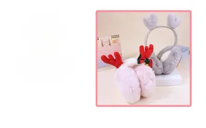 Detail of plush winter earmuffs with reindeer antlers and festive bow decorations