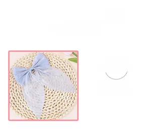 Macro detail of a light blue mesh bow accessory with sparkling rhinestone embellishments