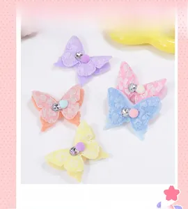 Détail de 5 pinces à cheveux papillon en dentelle dégradée avec pompons et petits strass