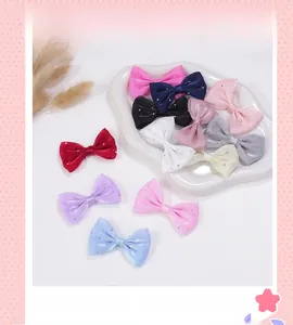 Macro shot of colorful mesh ribbon bows with shiny rhinestones for DIY hair accessories