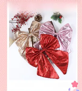 Glittery Christmas bow ornaments in gold pink and red for festive tree decoration
