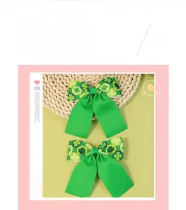 Detail view of St. Patrick's Day green clover ribbed ribbon bow hair clips set