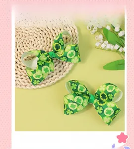 Detailed macro shot of green St. Patrick's Day ribbon bows with clover prints and metal clips