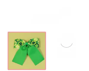Detail of St. Patrick's Day hair bow featuring shamrock patterns and green ribbons